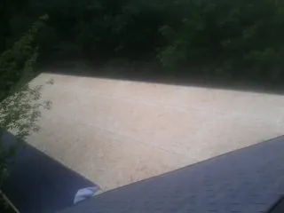 New OSB roof sheathing installed beside an existing shingle roof in Princeton